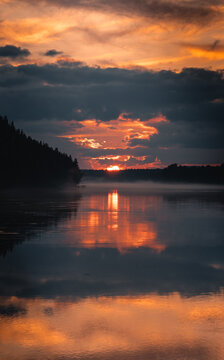 Dramatic Sunset with Fog Over Lake

