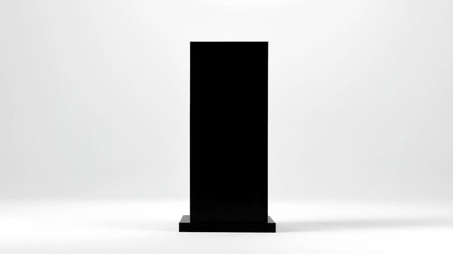 A tall, thin, black rectangular prism stands on a wider, flat rectangular base against a plain white background
