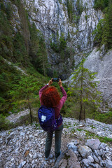 Hiker woman photographing cliffs