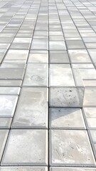 A vertical view of grey concrete paving blocks creating an orderly pattern