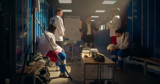 Ice Hockey Coach Standing in Front of His Team in the Locker Room, Pointing at a Whiteboard with a Plan. Players Listen Attentively as He Explains the Game Strategy and Tactics