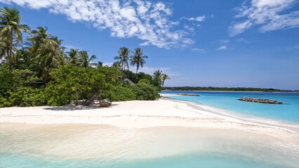 White sandy beaches with gentle waves, lush tropical trees, and turquoise water with distant rock barriers.