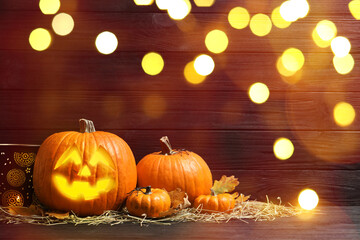 Obraz premium Halloween jack-o-lantern. Pumpkin with carved creepy face, bokeh effect