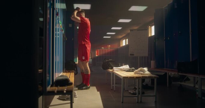 Frustrated Soccer Player Storms Back into the Locker Room, Throwing the Ball Aggressively Against the Wall. Athlete&rsquo;s Anger Reflects Disappointment After a Tough Match and a Loss