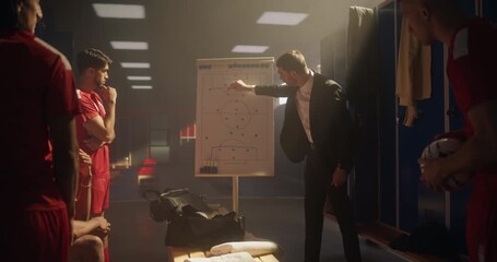 Soccer Coach Standing in Front of His Team in the Locker Room, Pointing at a Whiteboard with a Plan. Football Players Listen Attentively as He Explains the Game Strategy and Tactics - Powered by Adobe