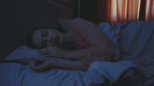 beautiful young woman lying in bed ghost pulling the blanket off sleeping person evil demon witch in night dark room flashes lightning storm rain. adult girl has nightmare sleeps paralysis bad dream