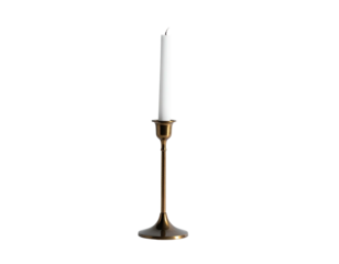 A gold-colored candlestick with a white candle against a stark black background
