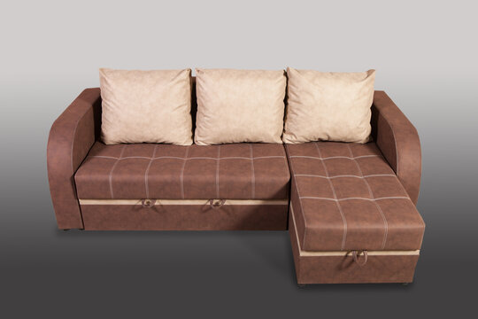 Isolated sofa bed with fabric upholstery on grey gradient background.