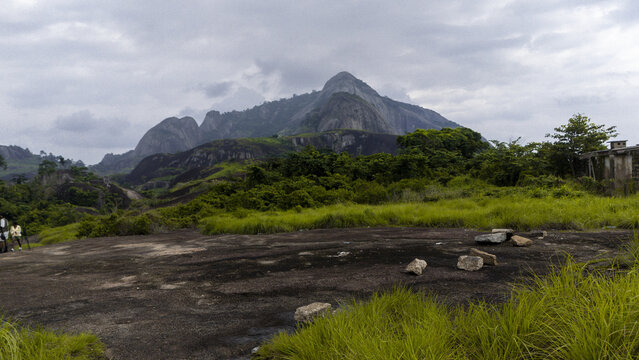 Aerial view of the rocky landscape with scattered boulders and lush greenery leading up to the majestic Ida mountain, Ida really, Ondo, Nigeria.
