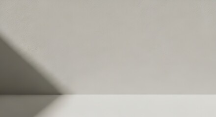 Fototapeta premium Minimalist studio background with soft light and shadow, perfect for product display and design.