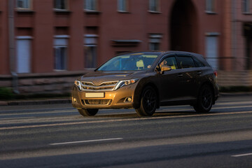 car moves along a city street in the morning