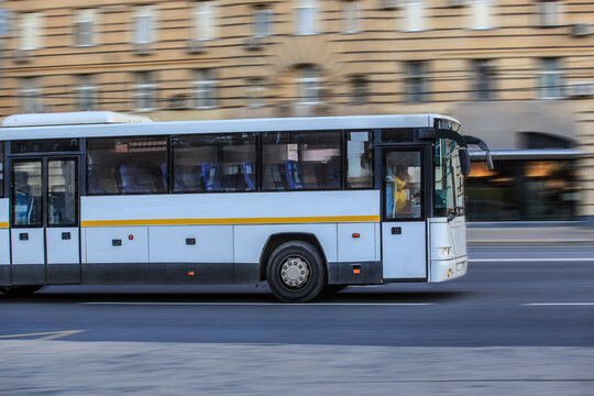 Fototapeta Bus driving down the street in the city