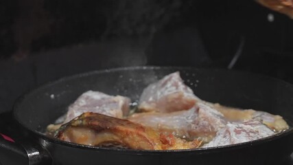 Cooking Delicious Meat in a Frying Pan with Tongs is a staple skill for any aspiring chef Delicious crispy meat is frying in a pan, with tongs in action, making it perfect for cooking enthusiasts ever