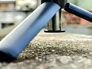 close up of a tripod legs on solid surface 