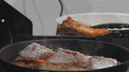 Cooking Delicious Meat in a Frying Pan with Tongs is a staple skill for any aspiring chef Delicious crispy meat is frying in a pan, with tongs in action, making it perfect for cooking enthusiasts ever