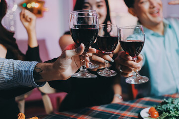 Diversity, dinner and group of people toast celebration together at party. Friends, happy and celebrate with food, wine and friendship for love, support and cheers champagne at business function
