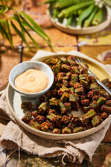 Okra prepared with parmesan cheese and garlic butter in the airfryer. Served with a spicy dip.
