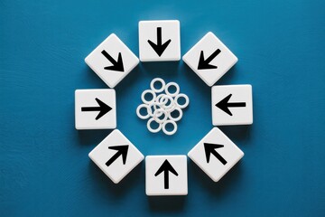 Conceptual image of arrows on white blocks converging on a central point, representing teamwork, shared goals, and strategic focus