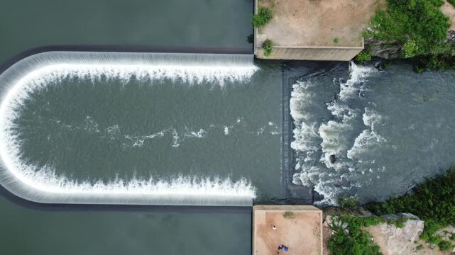 Aerial view of the river dam behind Zuma Barracks, where the water flows powerfully contrasting with the calm reservoir, Suleja, Niger, Nigeria.