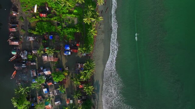 Wewak East Sepik Province Madang Papua New Guinea aerial drone PNG Birdseye view coastal neighborhood village town buildings Pacific Ocean pristine untouched beach coastline shore waves static