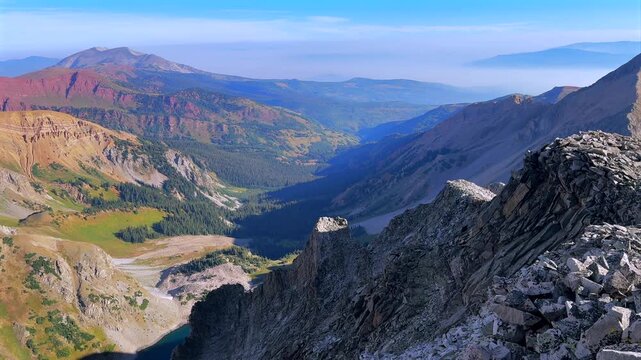 Capitol Lake Aspen Snowmass Rocky Mountain nature landscape valley view Capitol Peak Wilderness North East Ridge Route Mount Daly K2 Clark Peak aerial drone Colorado sunny blue sky morning clouds pan