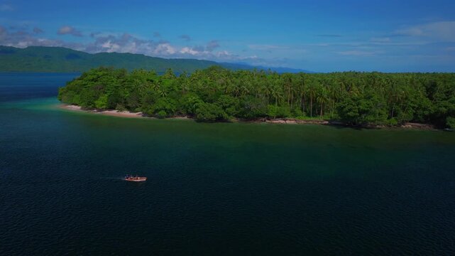 Fishing power boat Yuo Island beach shoreline remote pristine untouched tropical Mushi island coastline village Wewak Madang Cape Wom Papua New Guinea aerial drone PNG birds summer morning blue sky