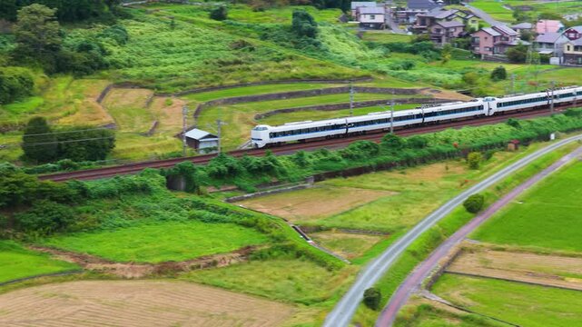 Japanese Train Passing Countryside Farms and Small Rural Town in Shiga, Japan