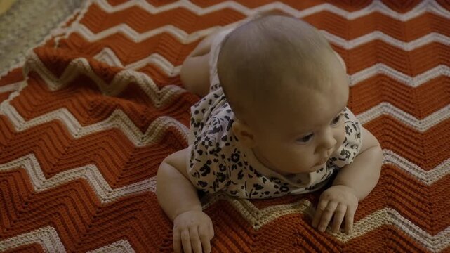 Four and a half month old baby girl on a blanket