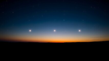 Six bright points of light aligned in the twilight sky above a dark, silhouetted horizon.