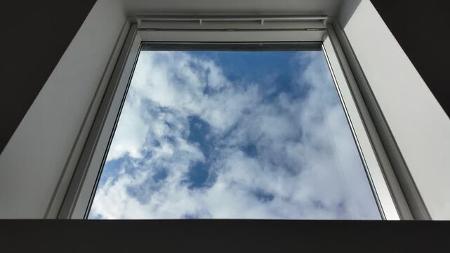 Fast-moving clouds seen through a skylight window in timelapse
