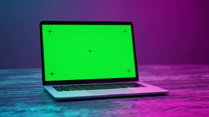 Dynamic Green Screen Laptop on Textured Surface with Neon Lighting - Ready for Your Content! - Powered by Adobe