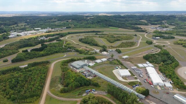 Aerial view of Millbrook Proving Ground, a test track facility, surrounded by lush greenery and winding roads, Bedford, England, United Kingdom.