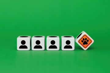 Exclusion of pets from a group of people, symbolized by dice with person and paw print icons on a green background