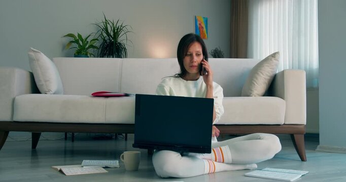 Student revises for university exam while reading notes at home. Concept of academic preparation indoors