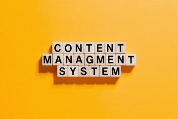 The phrase Content Management System spelled out with white letter tiles on a vibrant yellow background, representing digital media organization and web development