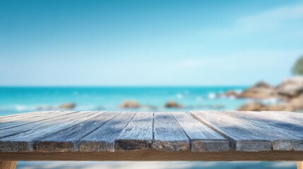 A serene wooden table overlooking a tranquil beach scene with clear blue waters and distant rocks.