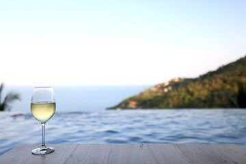 Wine glass close-up in real life, beautiful blurred background of the drink in the glass