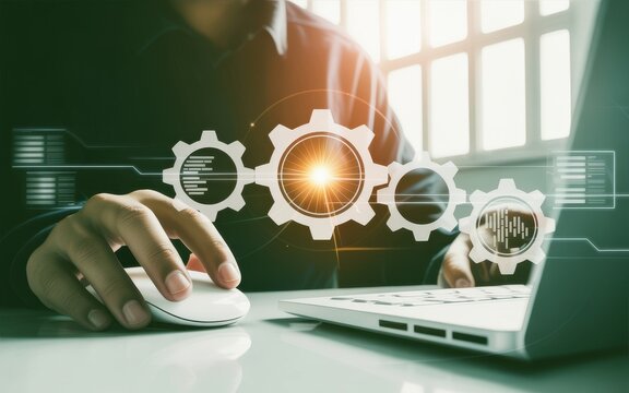Businessman using a laptop with a digital overlay of interlocking gears, representing business process automation and operational efficiency