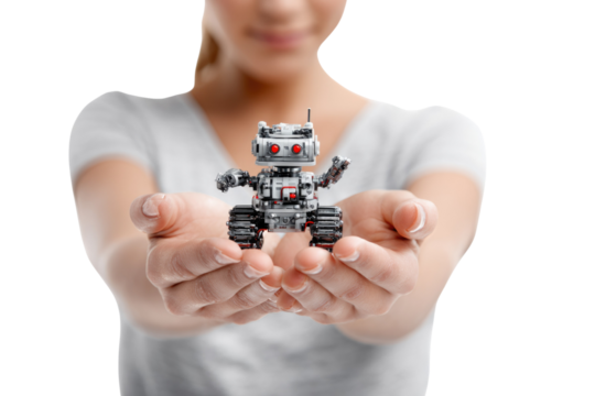 A person gently holds a small, intricate gray robot with red eyes and tank treads in cupped hands, symbolizing human connection with AI. background removed