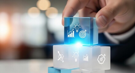 Hand placing a glowing cube with business icons on top of other cubes, representing growth and strategy.