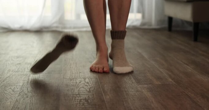 Soft socks slide off as someone steps onto a warm wooden floor. The coziness of the underfloor heating creates a welcoming atmosphere in the room, perfect for relaxing.