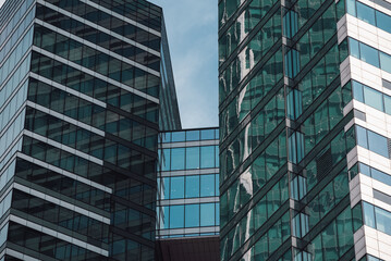 Fototapeta premium mirrored windows of the facade of an office building 