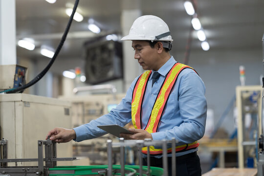 Male engineer, Industry factory. Asian male plant engineer working and checking operation of production system at industry factory