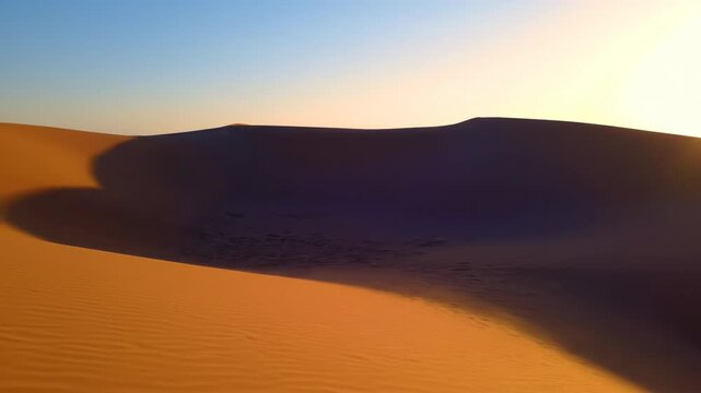 Long shadows gracefully moving across sinuous desert dunes as the sun progresses solitude, wilderness, sand