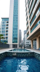 Naklejka premium Urban Oasis: Swimming Pool with Cityscape Views in a Modern Apartment Complex.