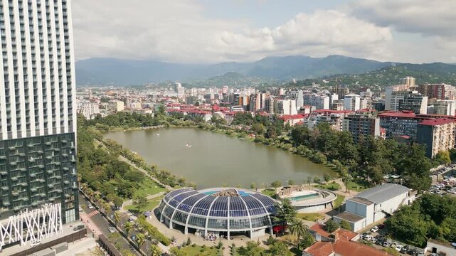 Batumi, Georgia - 7th august, 2025: Aerial view Batumi Georgia dolphinarium with pools beside Nurigeli lake and modern skyline in summer day
