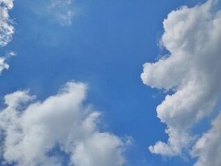 clear blue sky with a few clouds. The sky is very bright and the clouds are scattered throughout	