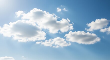 A bright sky with soft white clouds scattered across a blue background. The clouds are fluffy and partially cover the sky, creating a calm and natural atmosphere