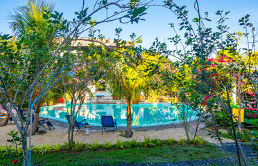 Tropical resort hotel with pool palm trees jungle huts Thailand.