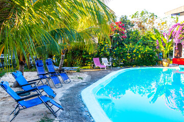 Tropical resort hotel with pool palm trees jungle huts Thailand.